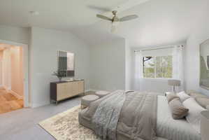 Bedroom featuring a vaulted ceiling, large window, ceiling fan with integrated lighting, and plush carpeting - Virtually staged