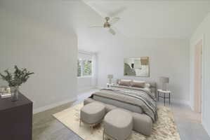 Carpeted bedroom featuring a ceiling fan, a window with exterior tree views, and white baseboards - Virtually staged
