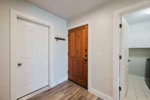 Unit has attached garage. White door is garage, brown door is entry door, opoen door is laundru room