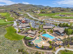 Expansive community amenities including a multi-level pool with integrated slide, a separate resort-style pool, and a hot tub
