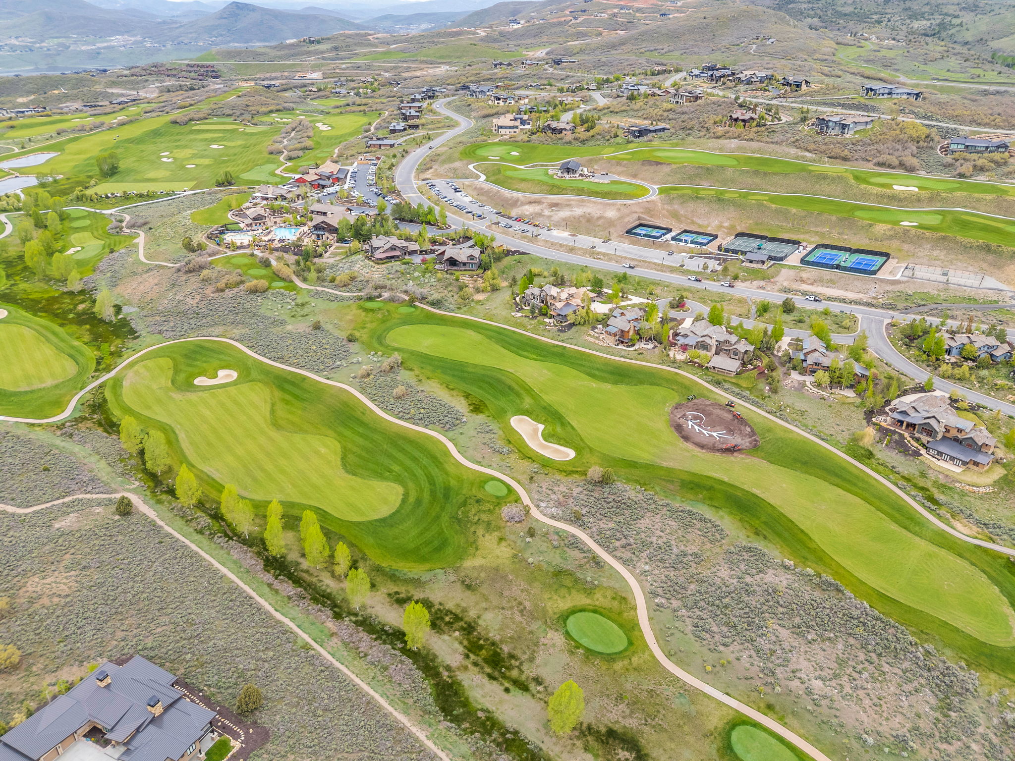 Expansive golf course landscape with multiple greens and sand traps