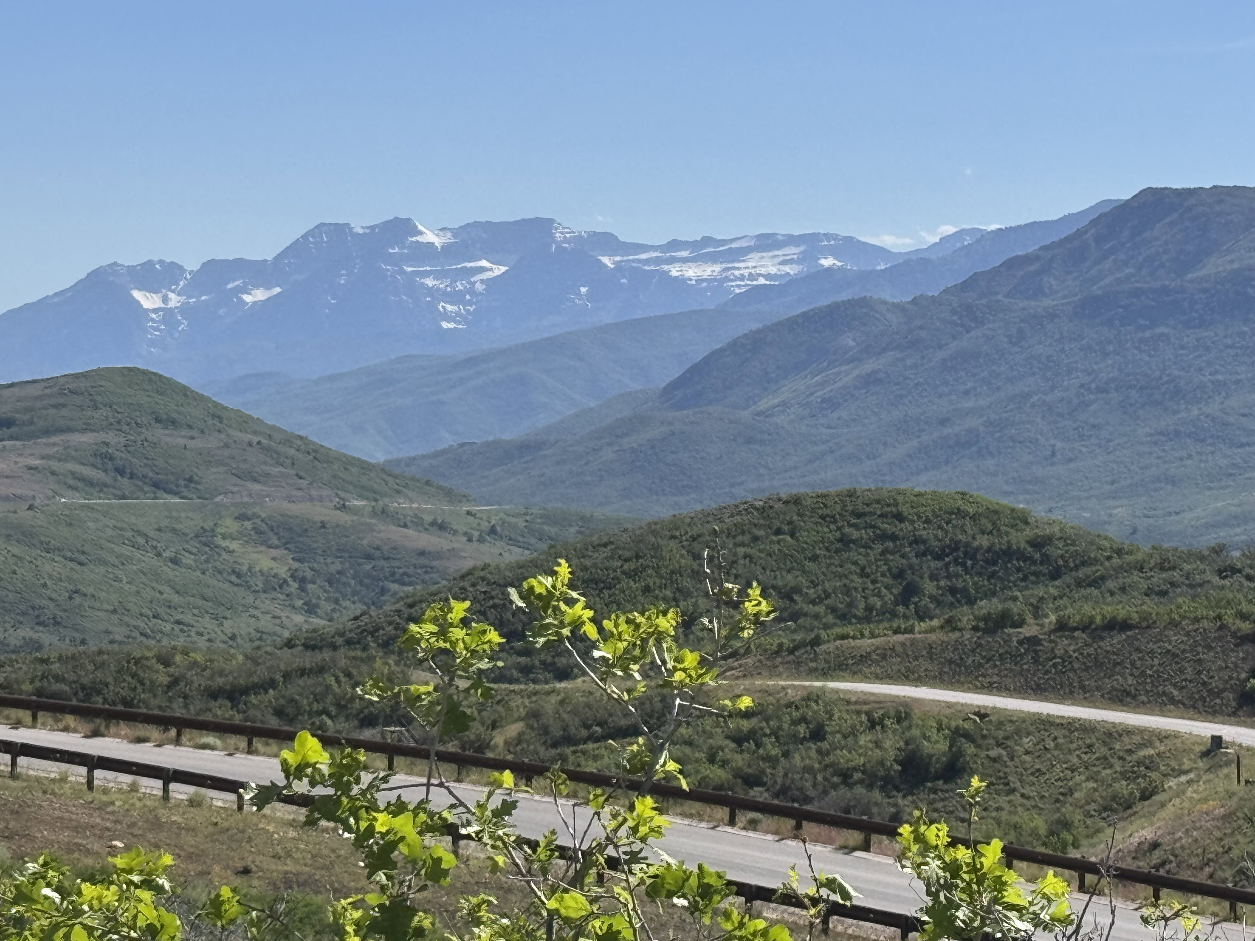 Sweeping mountain range backdrop with distant snow-capped peaks