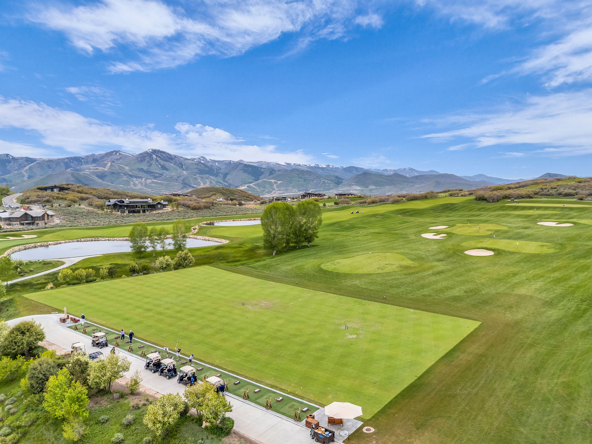 Expansive golf course setting featuring manicured greens and multiple sand traps