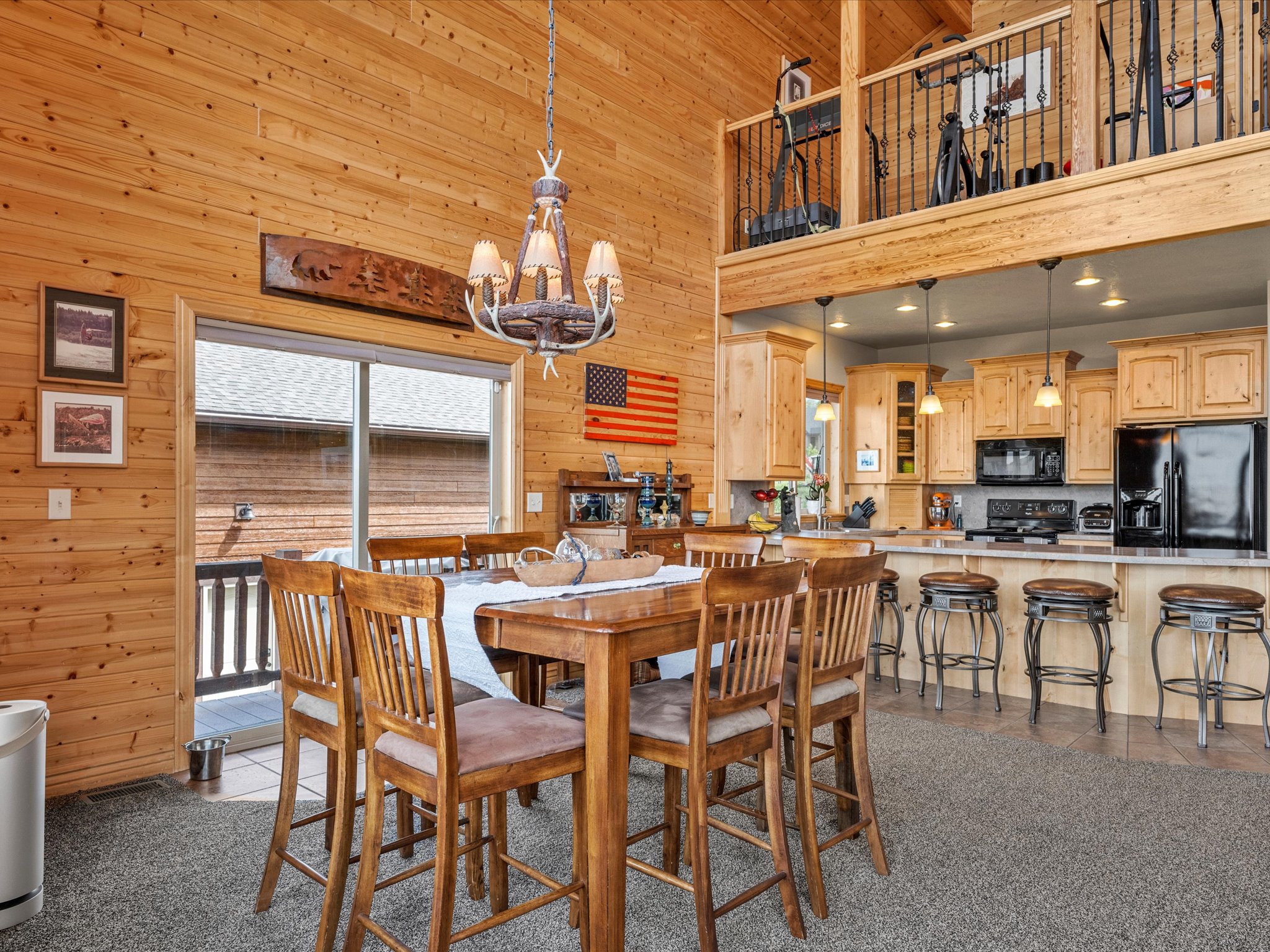 Vaulted wood-paneled interior featuring an open-concept kitchen and dining space