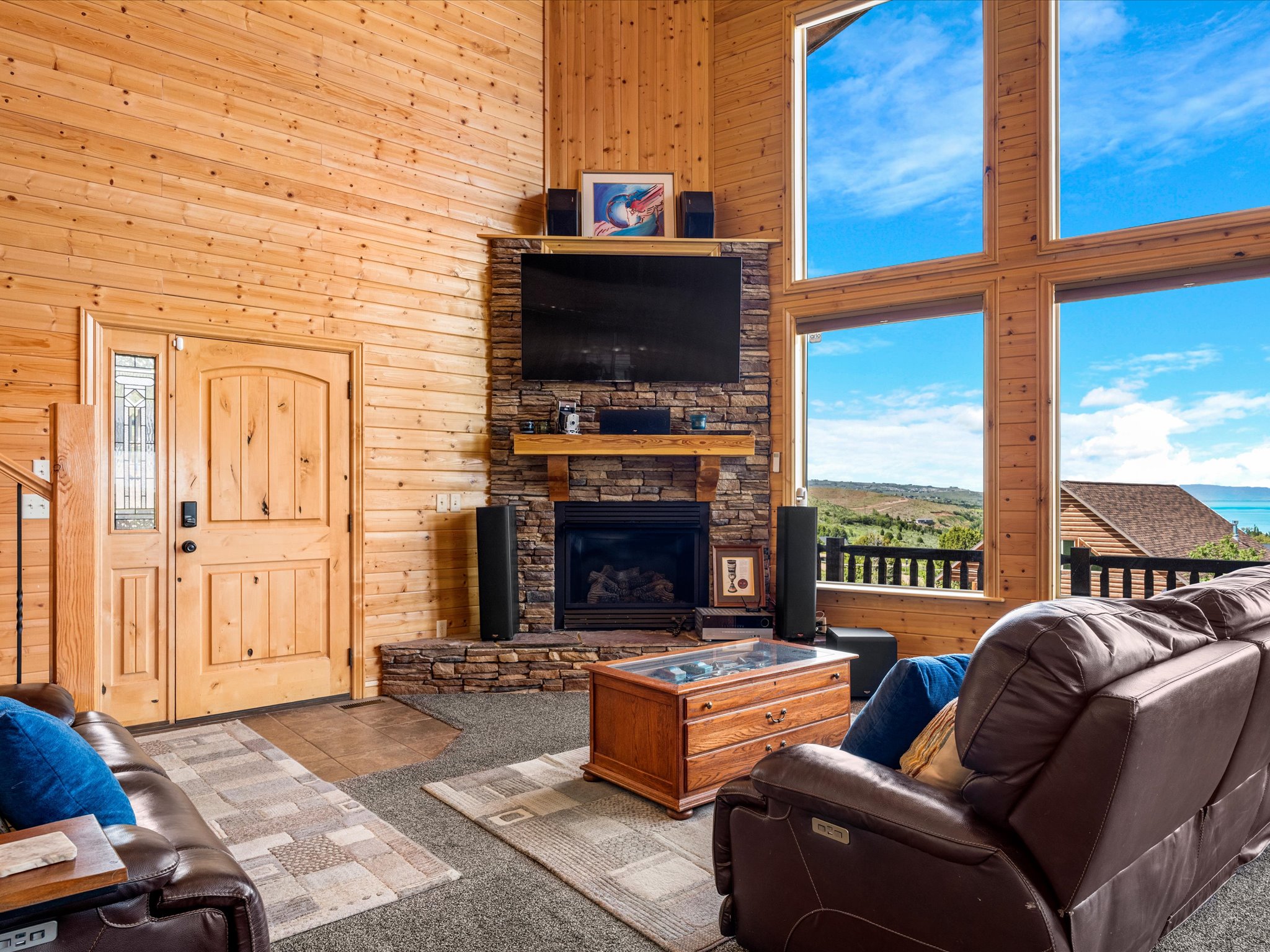 Vaulted wood-paneled ceiling and walls complement the floor-to-ceiling windows