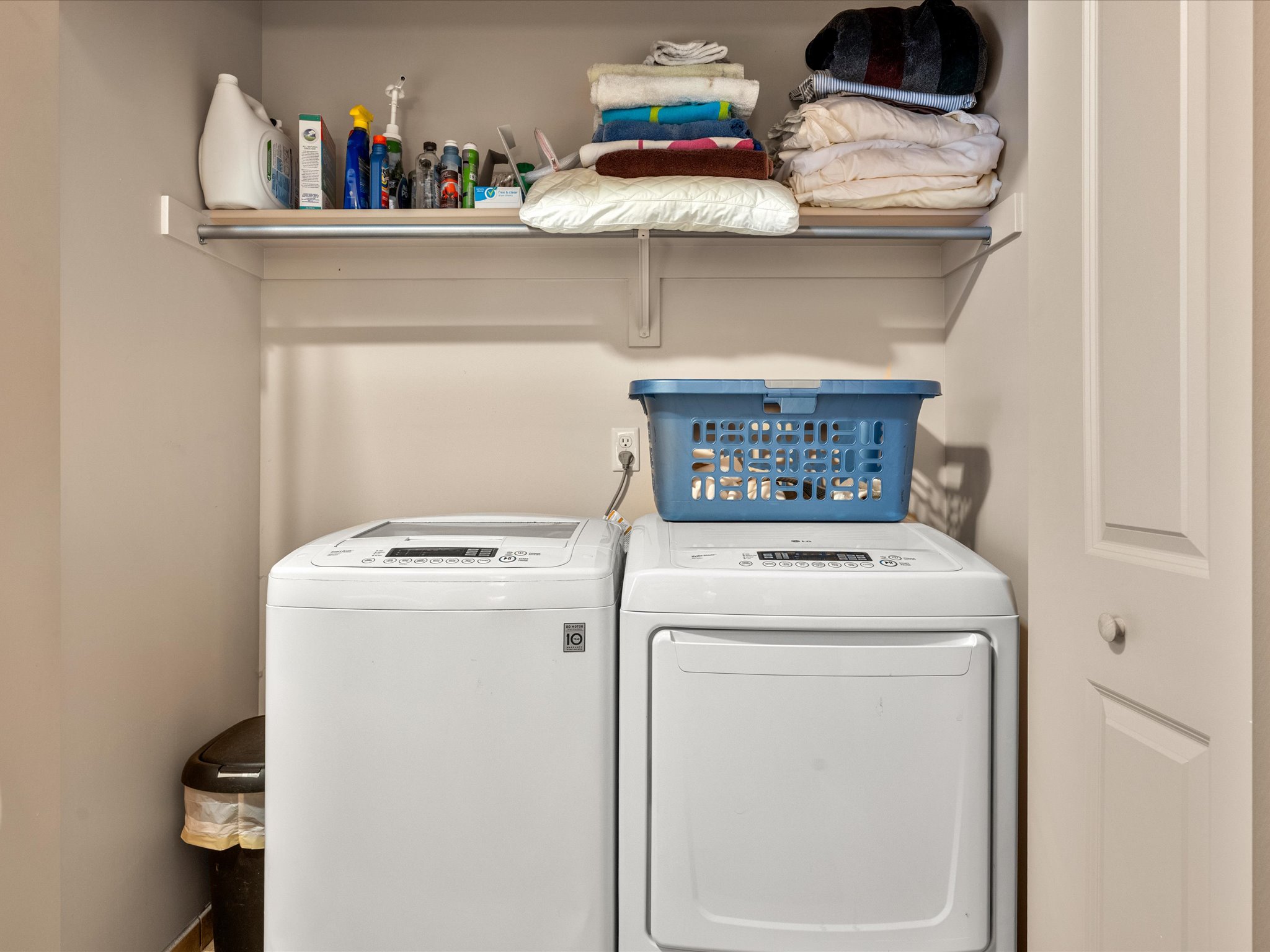 laundry area featuring a white top-load washing machine and a white front-load dryer