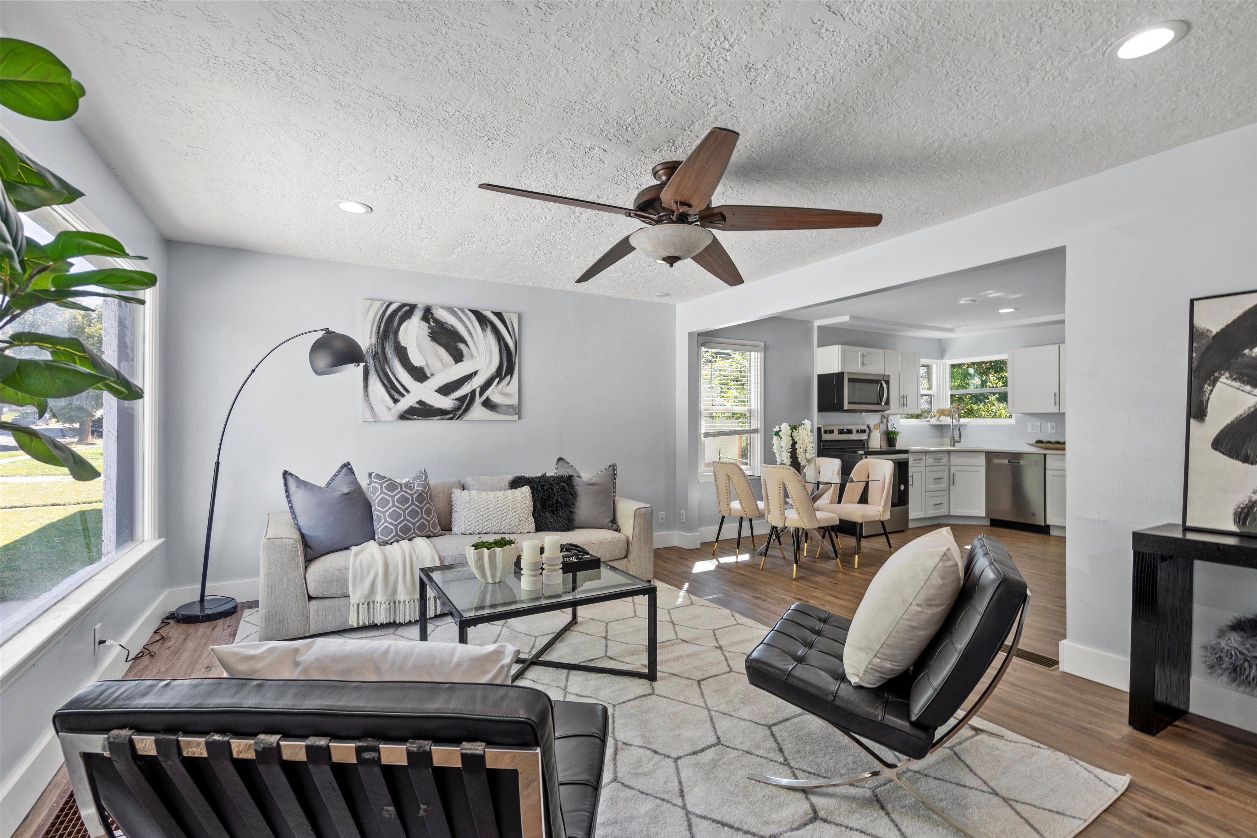 Living area featuring wood-finish flooring, recessed lighting, and a ceiling fan