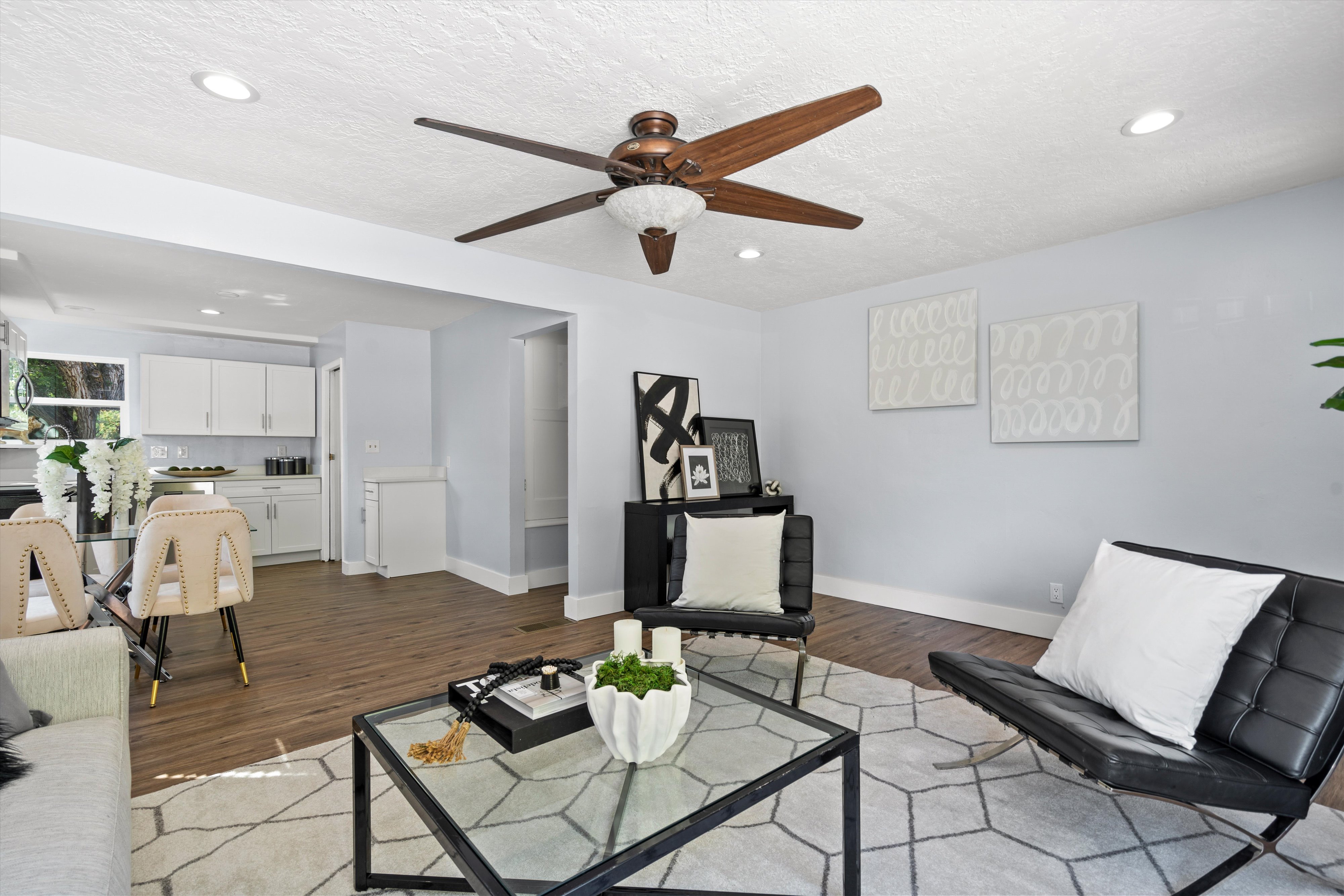 Open-concept living area featuring wood-finish flooring, recessed lighting, and a ceiling fan