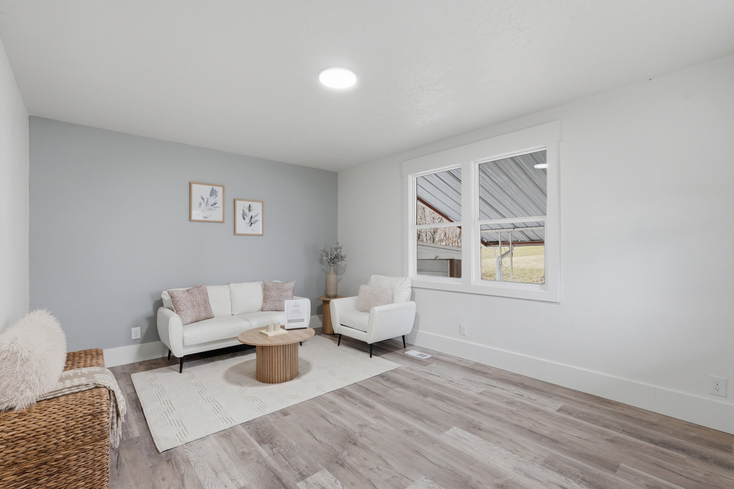 Spacious interior featuring wood-finish flooring, a contemporary window with white trim, and a recessed ceiling light
