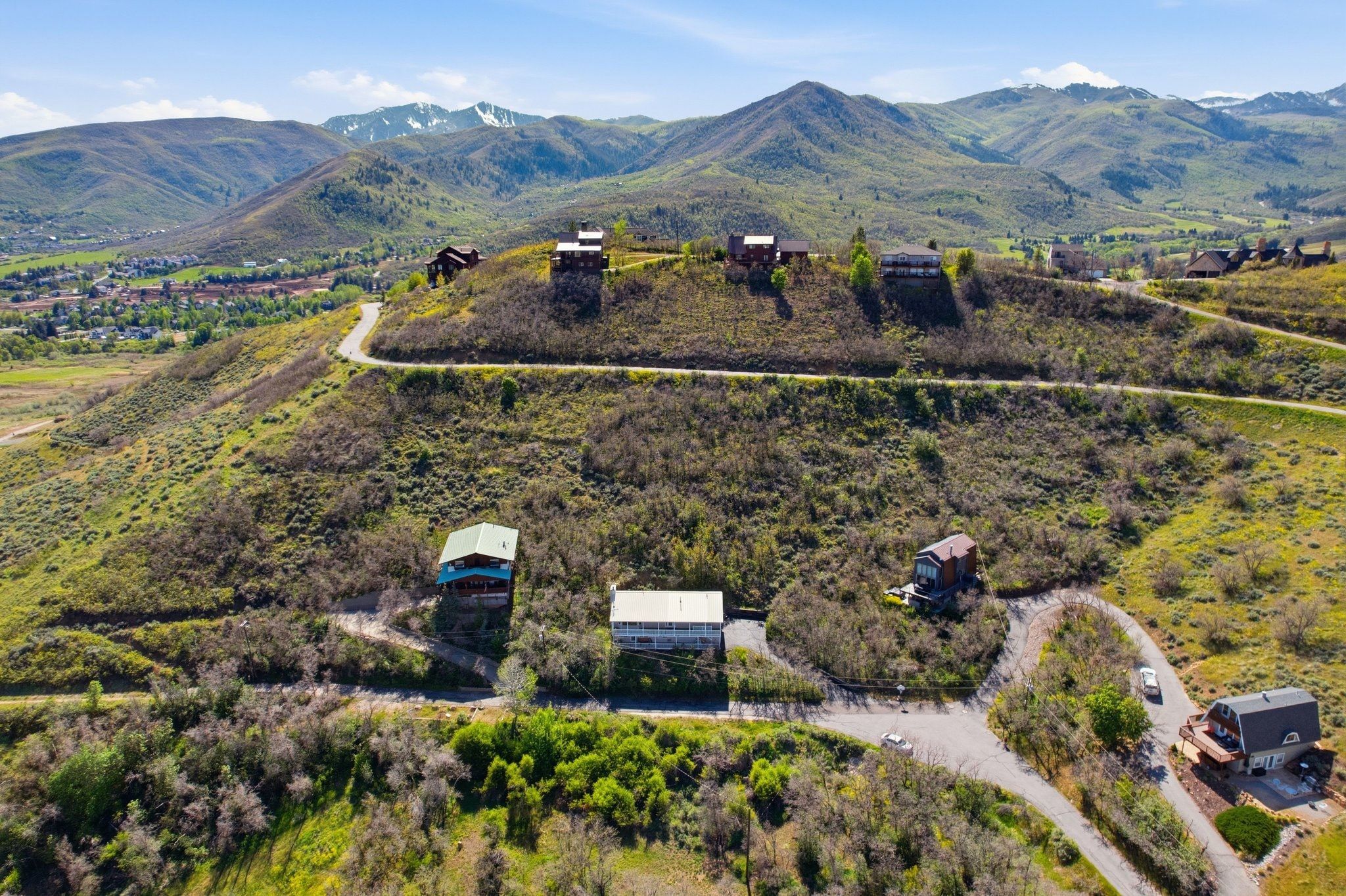 Mountainous landscape featuring multiple properties nestled into the hillsides