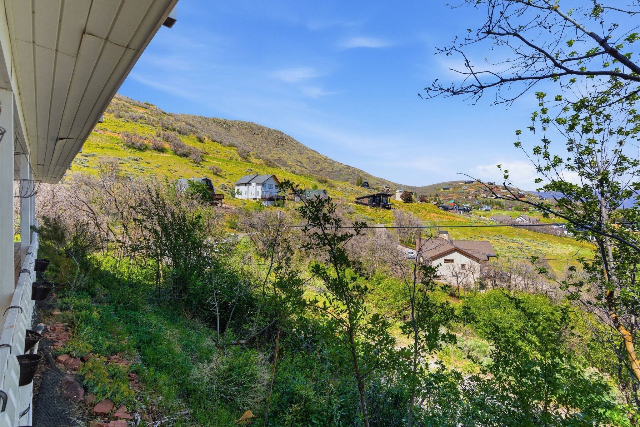 Terraced hillside setting with existing residences and a clear sky above