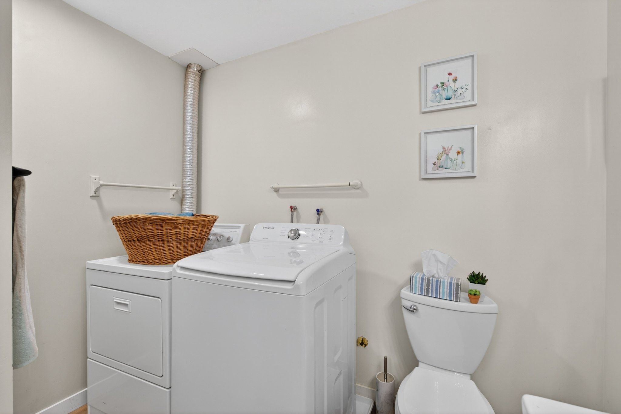 Dedicated laundry area featuring a white top-load washer and white front-load dryer