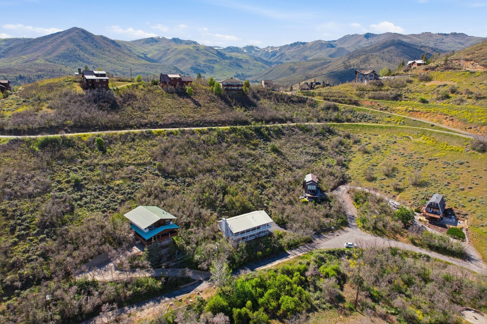 Expansive mountain landscape featuring multiple properties nestled into hillsides