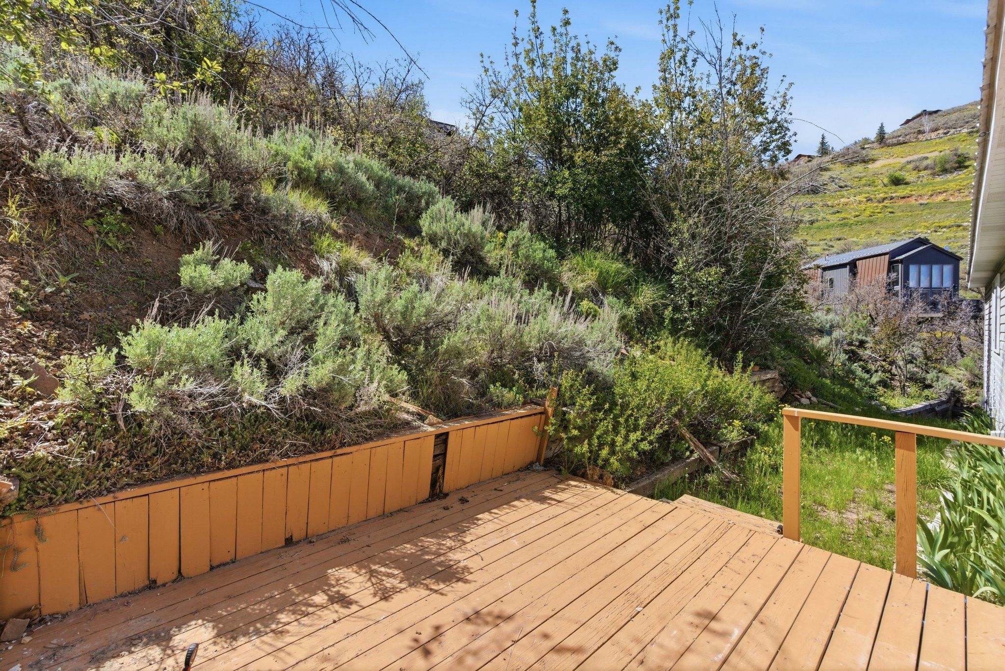 Wooden deck with a light brown finish and a matching wooden railing