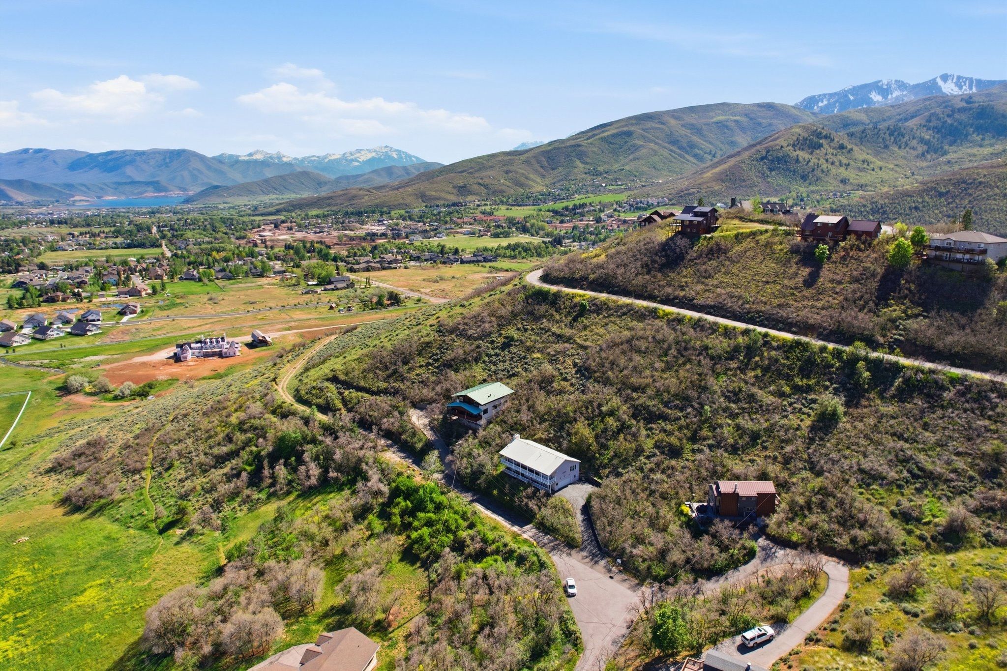 Expansive hillside property featuring multiple residences and a winding access road