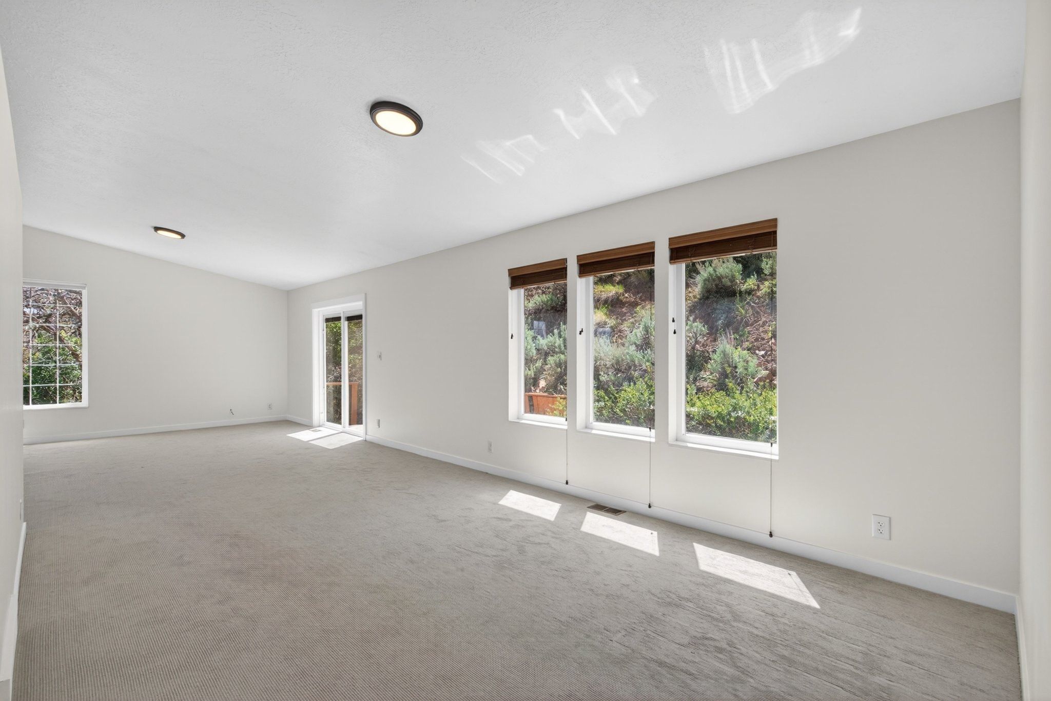 Spacious interior with neutral carpeting and light-toned walls