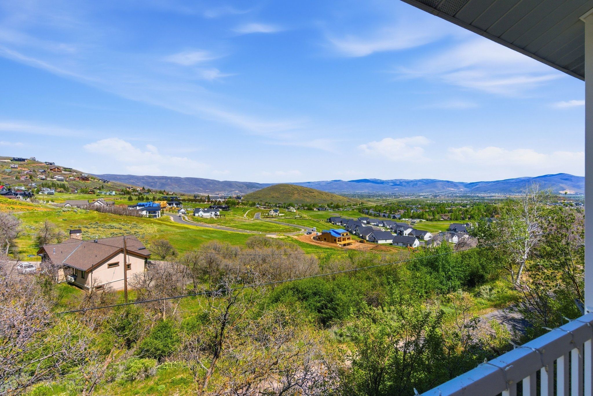 Expansive landscape featuring rolling hills and distant mountains