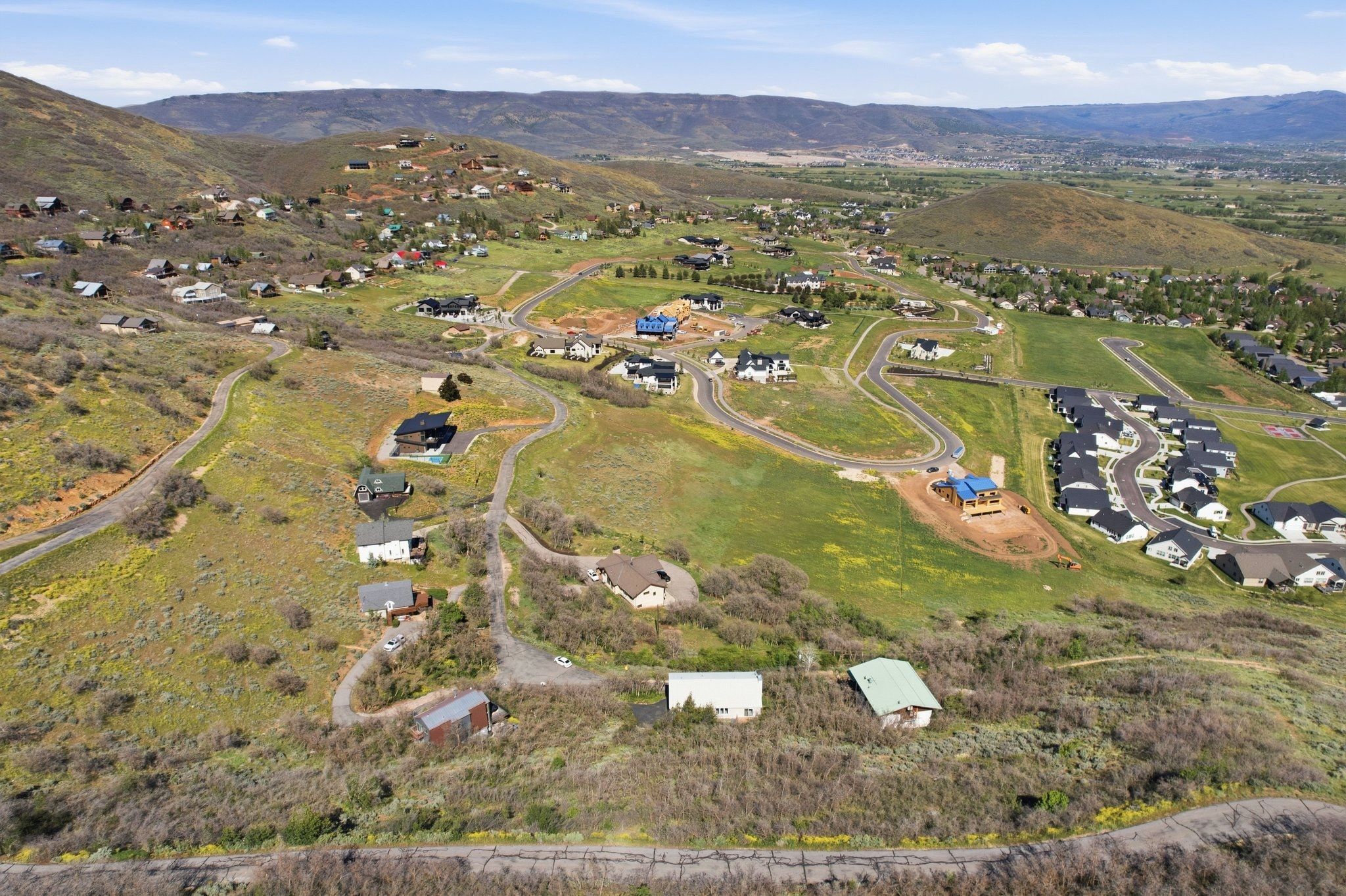 Expansive hillside property with diverse topography, featuring established residences and new construction