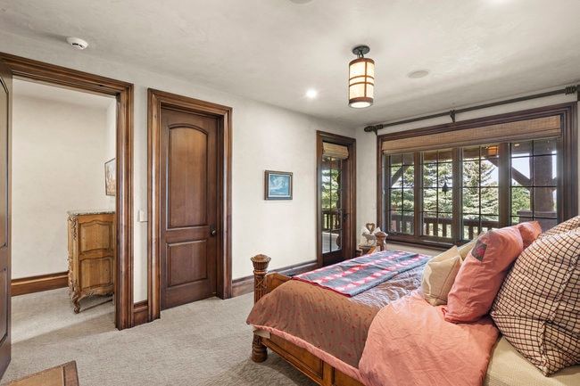 Room featuring a large window with multiple panes, providing natural light and tree scenery