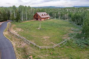 Rustic-style property featuring a wood and stone exterior under a gabled roof