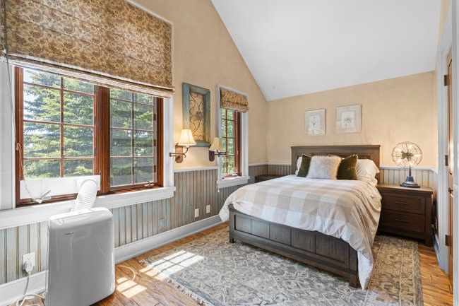 Vaulted ceilings and wood-finish flooring characterize this room