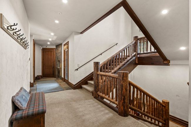 Rustic wood-finish staircase with natural log newel posts and spindles