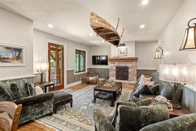 Stone-clad fireplace with wood mantle
