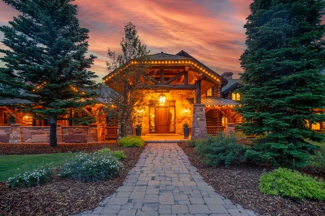 Stone and timber frame exterior featuring a prominent covered entry