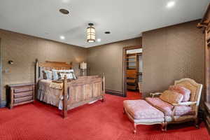 Room featuring patterned wall coverings, recessed lighting, and a central decorative light fixture