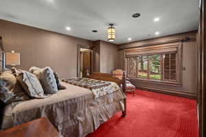 Textured walls with recessed lighting and a central pendant fixture