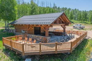 Expansive outdoor pavilion with a metal roof and exposed timber framing