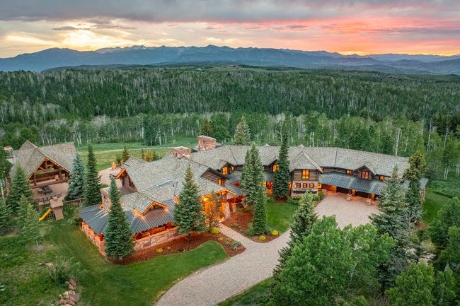Expansive property with a multi-gabled roofline and stone exterior accents