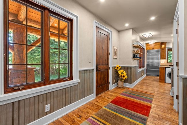 Interior space featuring wood-finish flooring, half-wall wainscoting, and recessed lighting
