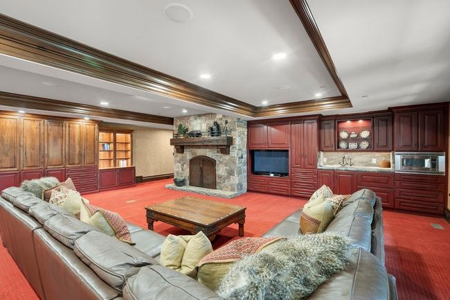 Stone-clad fireplace with a wood mantle