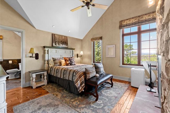 Vaulted ceilings and wood-finish flooring define this space