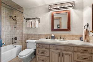 Bathroom featuring a single vanity with stone countertop, integrated sink, and an oil-rubbed bronze faucet