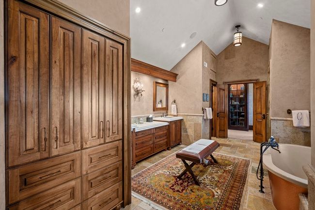 Integrated wood-finish cabinetry providing extensive storage