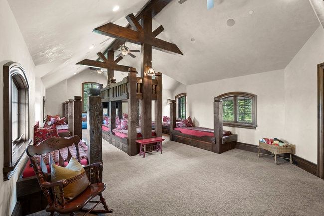 Vaulted ceiling with exposed wood beams, recessed lighting, and ceiling fans
