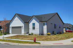 Modern exterior featuring white board-and-batten siding with gray stucco accents