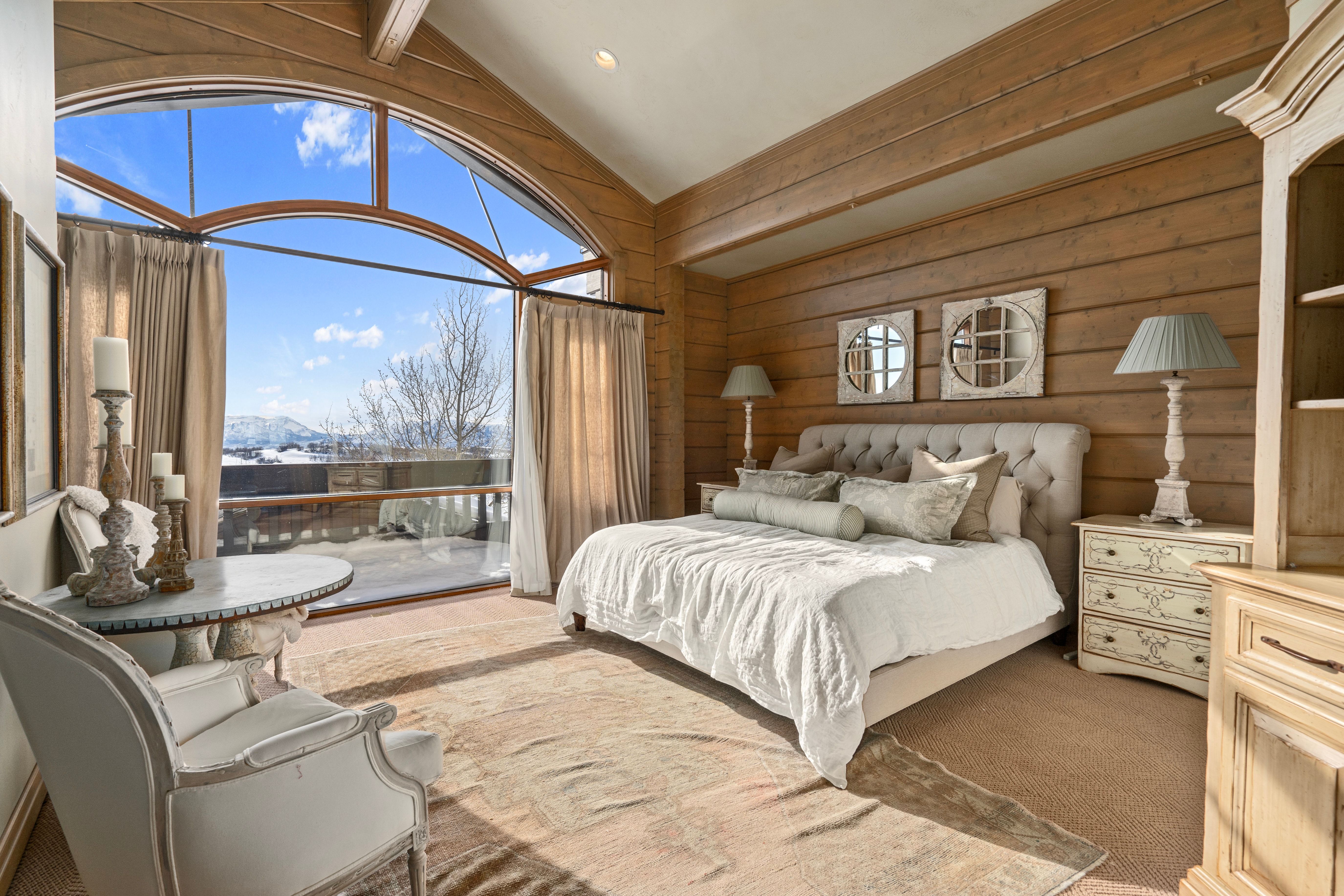Expansive arched window framing distant mountain ranges