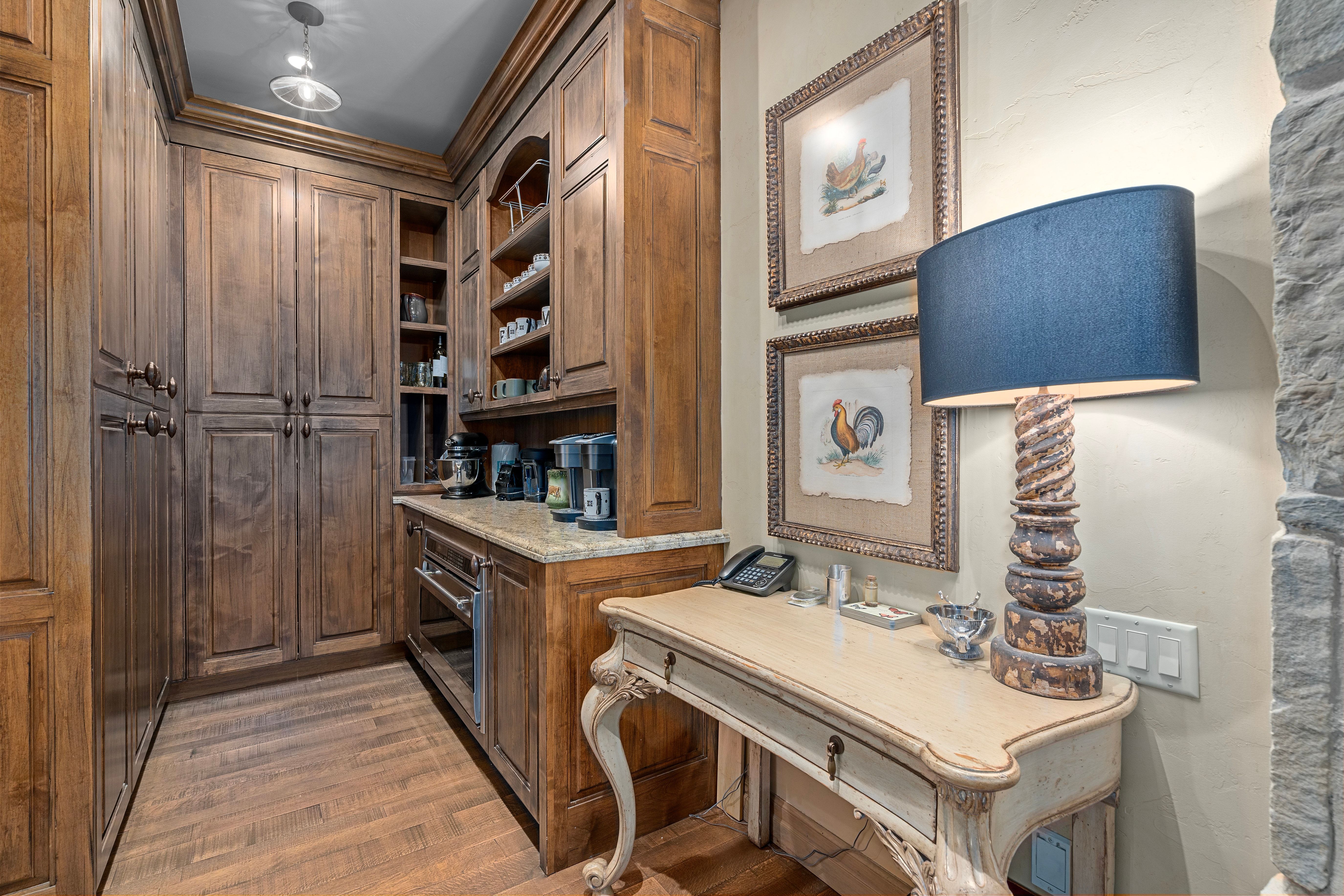 Custom wood cabinetry and shelving with integrated counter space and a built-in appliance