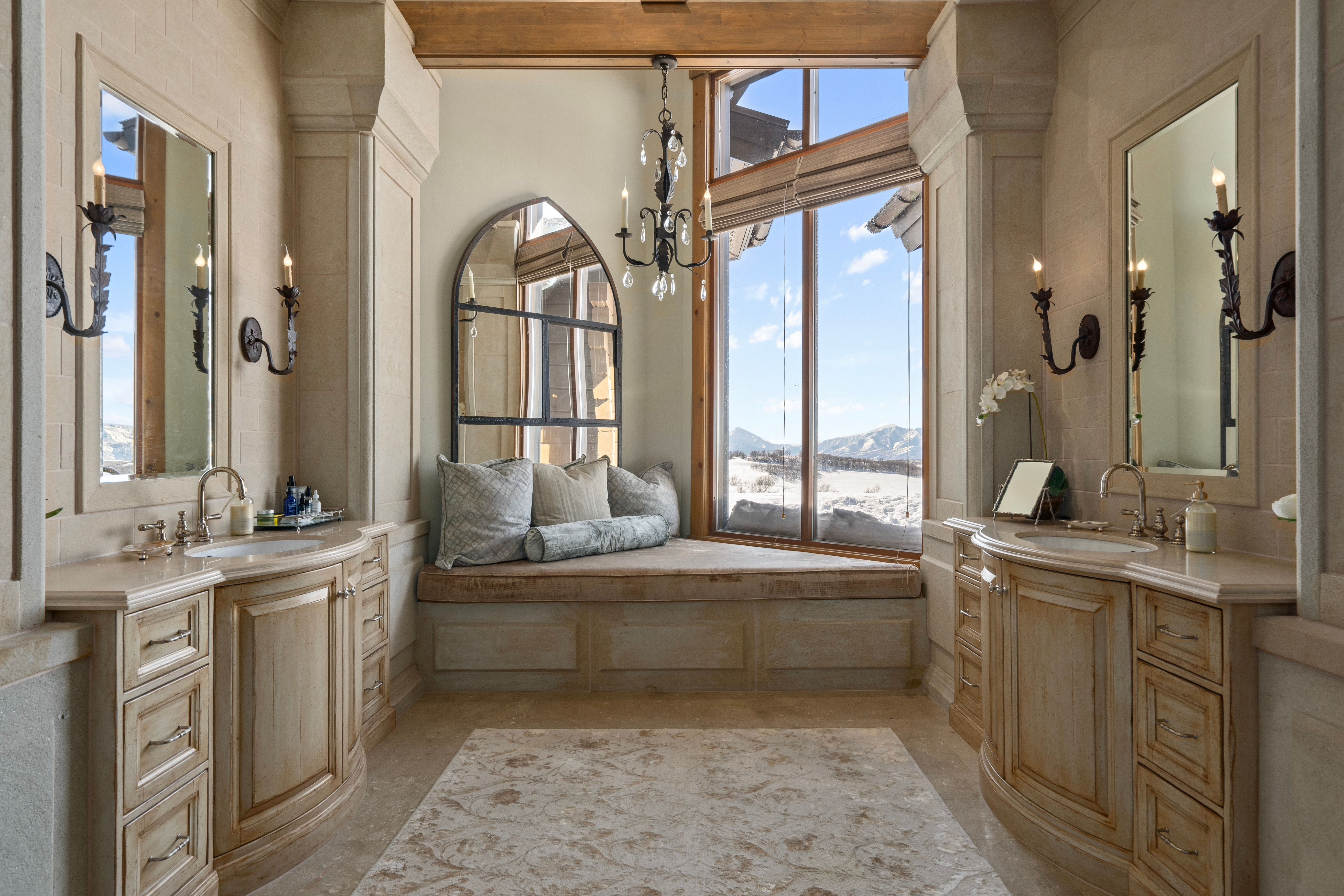 Expansive window with mountain scenery and a built-in window seat