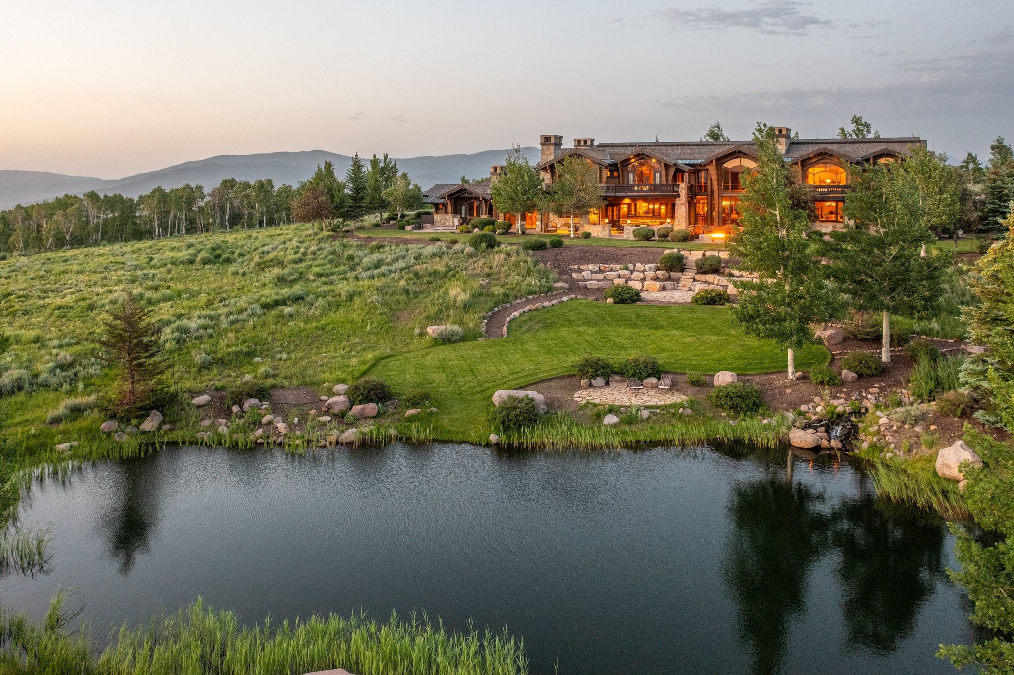 Expansive waterfront property featuring a large residence with multiple gables and dormers