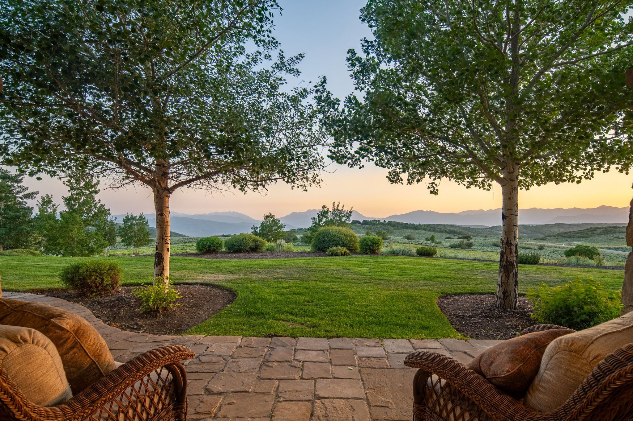Expansive patio featuring paver flooring and direct access to a large lawn