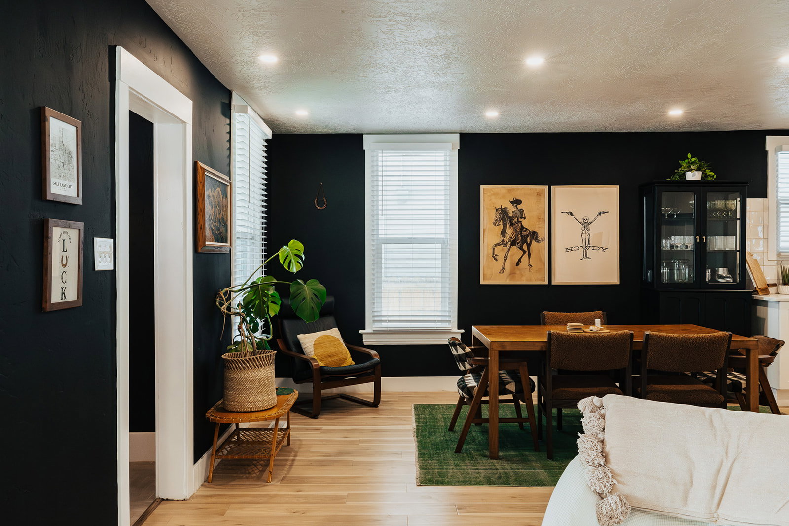 Open-concept dining area featuring light wood-finish flooring, recessed lighting, and white baseboards