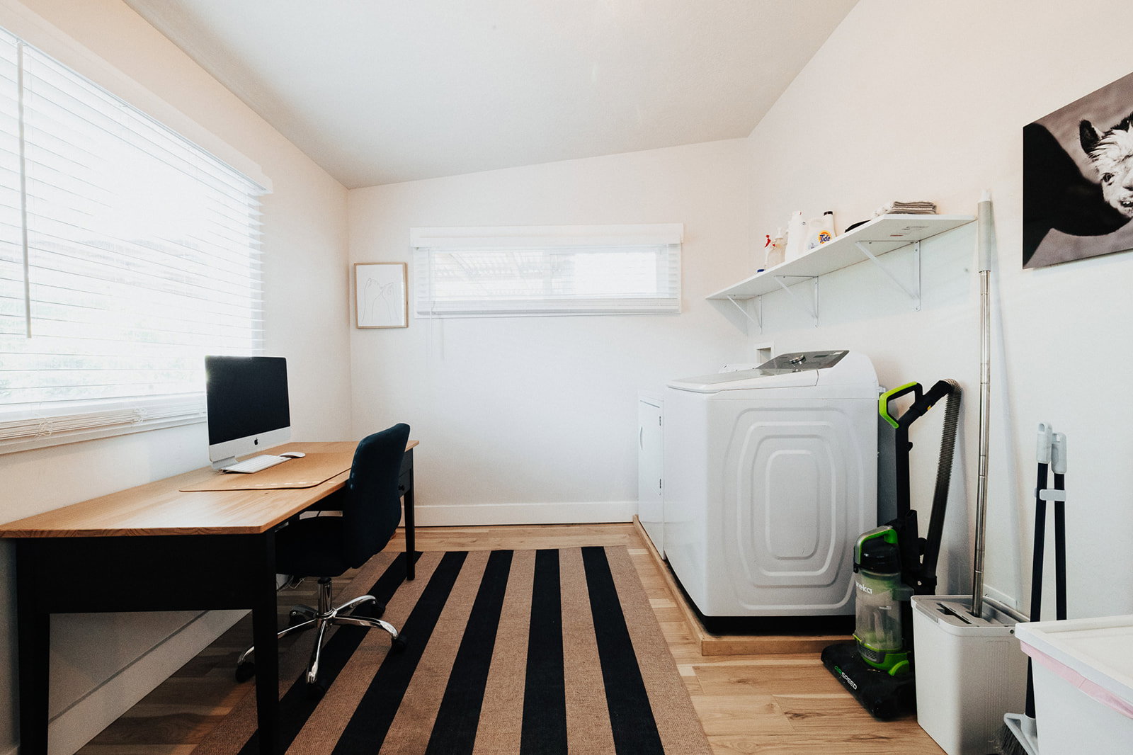 Versatile room featuring light wood-finish flooring, white walls, and multiple windows with blinds