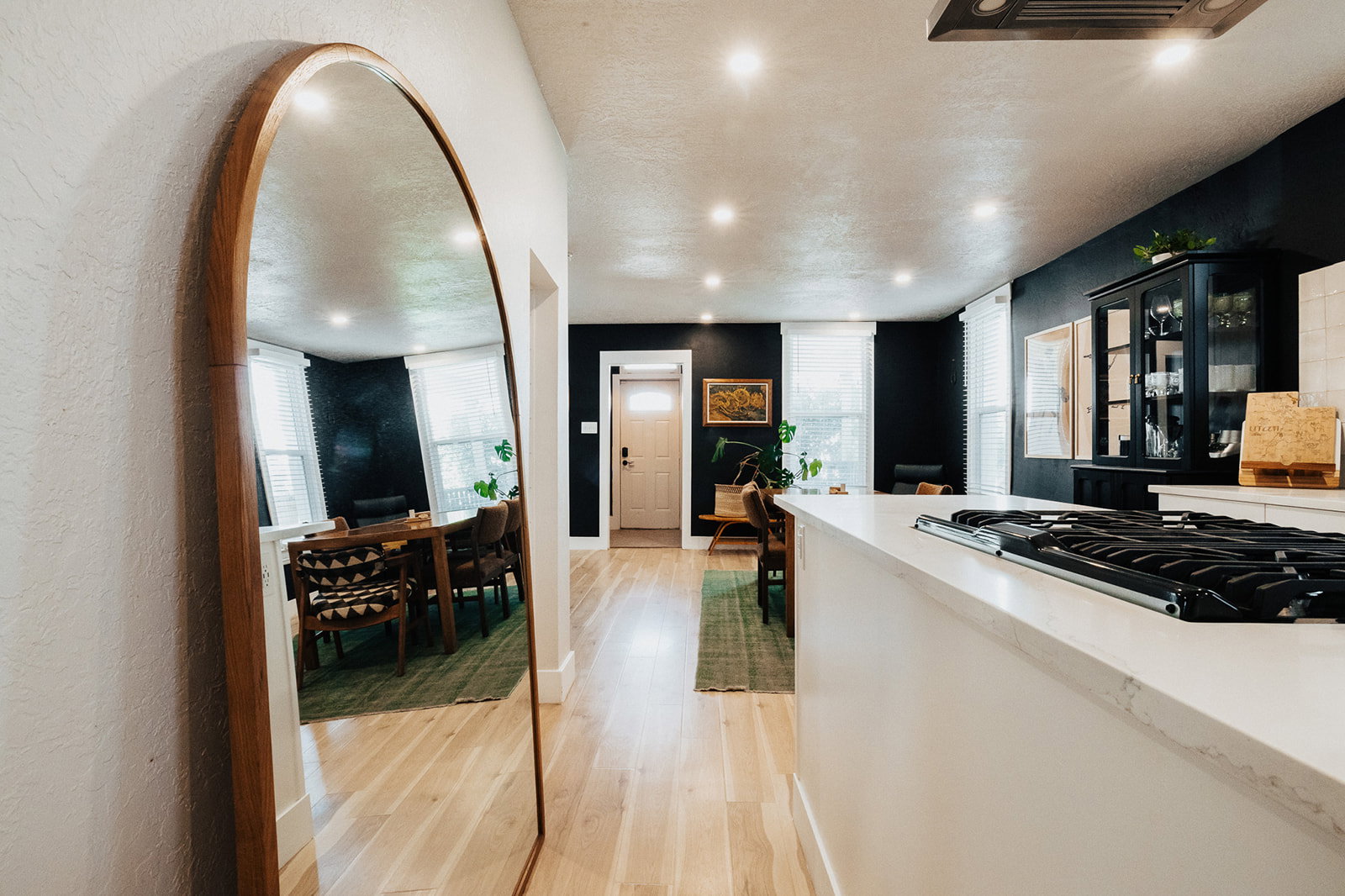 Kitchen island featuring a built-in cooktop and light-toned countertop