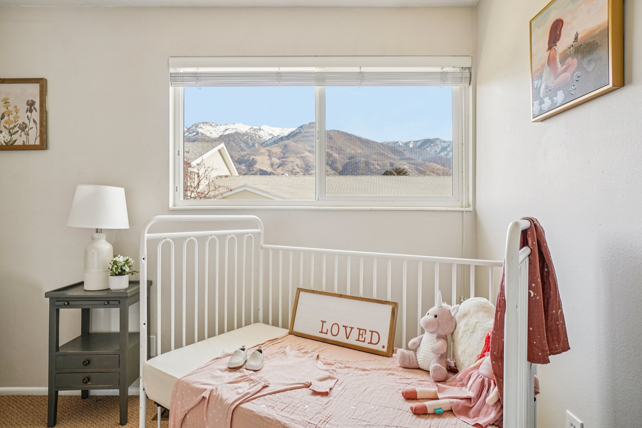 Bright room featuring a window with expansive mountain scenery
