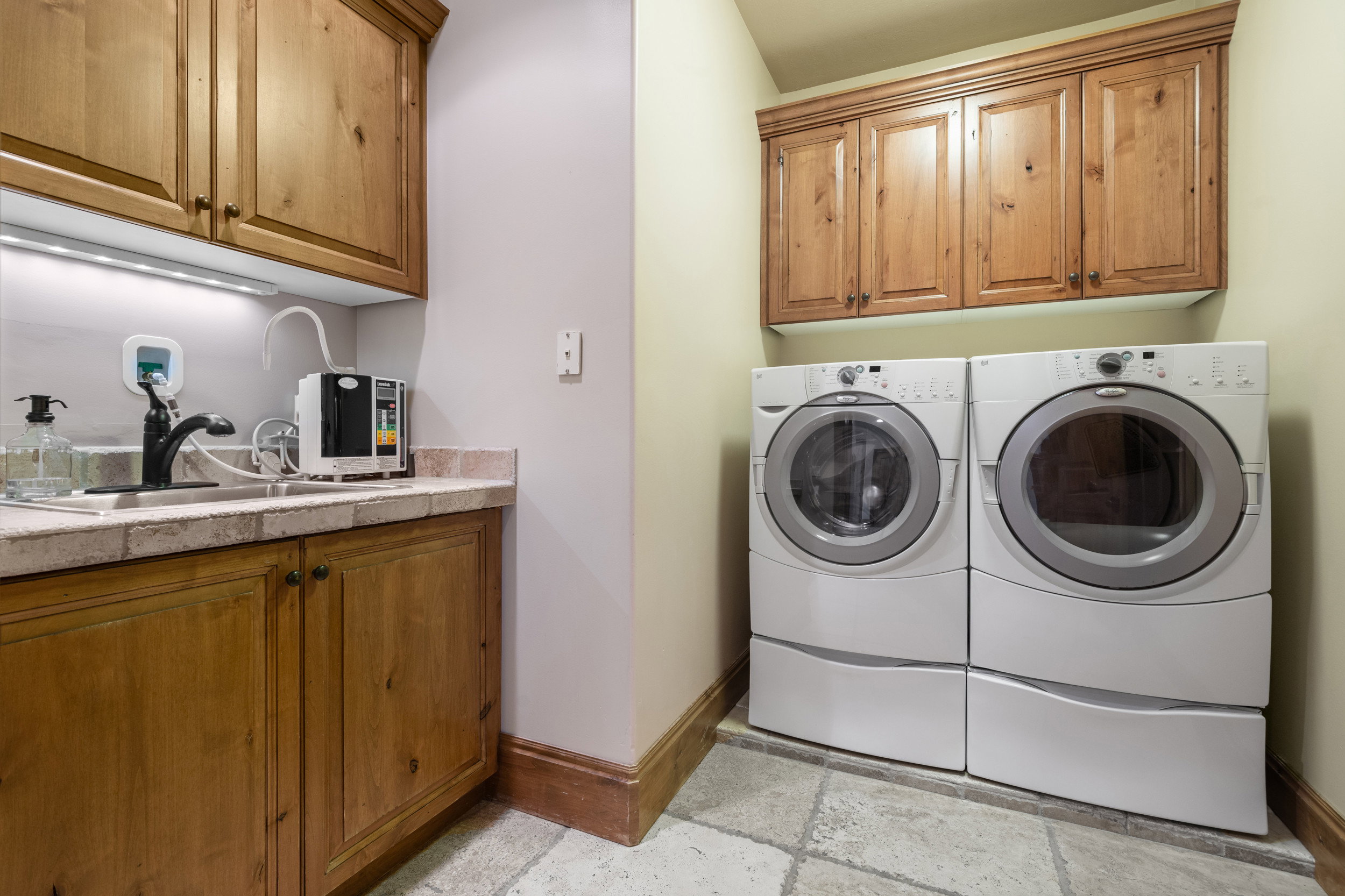 Spacious laundry room with sink and plenty of storage