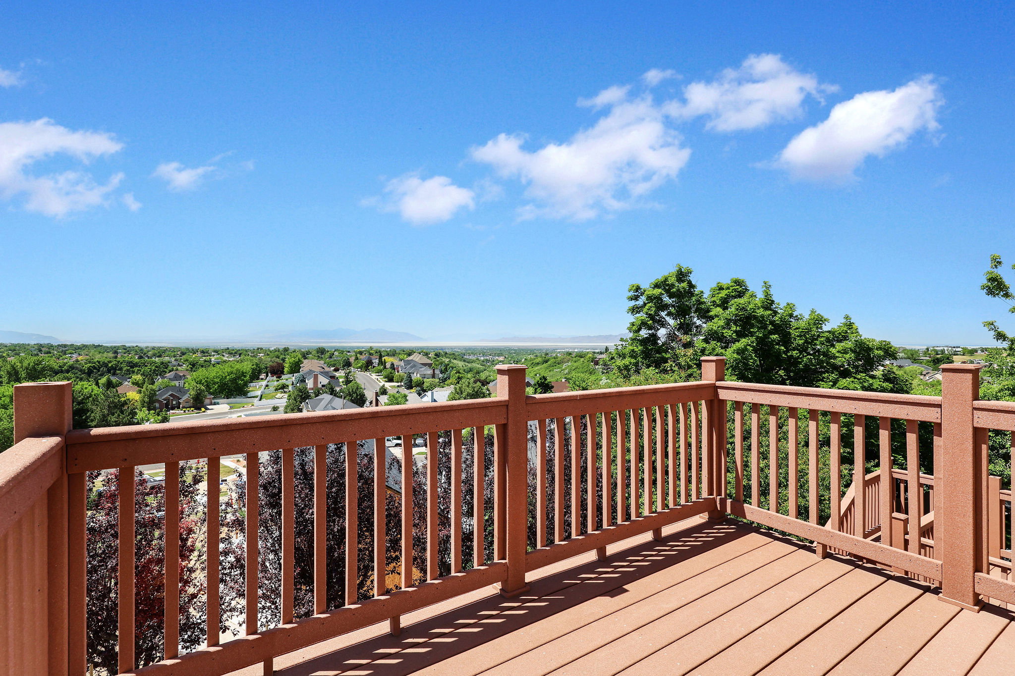 Spacious outdoor deck featuring composite decking and a sturdy railing system